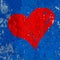 Red heart painted over grungy and old weathered dark blue wall texture background with painting peeling of