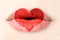 Red heart painted on woman lips close up