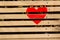 Red heart painted on a wooden bench