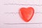 Red heart on a paper cardiogram background, top view, close-up