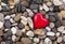 Red heart on pebbles