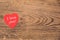 Red heart post-it with the text `I love you` on a wooden background