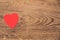 Red heart post-it on a wooden background