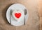 Red heart on rice heart shape on whiteplate