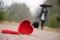 Red heart on the road and woman with luggage and umbrella