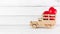 Red Heart Rubber on Wooden Toy Truck over white background. Love Concept with Copy Space