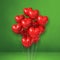 Red heart shape balloons bunch on a green wall background