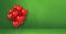 Red heart shape balloons bunch on a green wall background. Horizontal banner