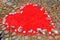 Red heart shape with flowers on cobblestones