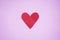 Red heart shape - a love symbol on pink background. Copy space for text and your creative design.
