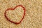 Red heart shape on uncooked quinoa