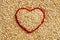 Red heart shape on uncooked quinoa background