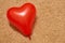 Red heart-shaped balloon on beige carpet. Valentines day concept