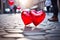 Red heart-shaped balloons on a stone street. Valentines Day concept.
