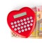 Red heart shaped calculator with euro banknotes