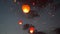 Red heart-shaped chinese lantern in the night sky. Footage. A large group of chinese flying lanterns.