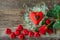 Red heart-shaped chocolates and roses placed on wooden floors and leave space