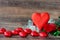 Red heart-shaped chocolates and roses placed on wooden floors and leave space