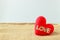 Red heart-shaped is handmade of frieze, with the word golden love placed on sackcloth and white background.