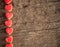 Red heart shaped jelly sweets on a vintage wooden background.