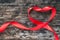 Red heart shaped ribbon awareness for World aids day campaign supporting people with HIV, STD disease