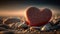 a red heart sitting on top of a pile of rocks.