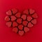 Red heart of small hearts on deep red paper background. Valentine day.