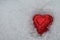 Red heart in snow