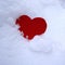 Red heart in snow. Love concept.