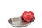 Red heart in stainless steel kidney-shaped bowl isolated