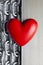 Red heart on steel chains and aluminum plate background