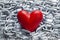 Red heart on steel chains background