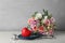 Red heart, stethoscope and bouquet on white table