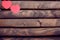 Red heart stickers on a wooden background