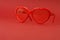 Red heart sunglasses on red background