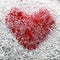 red heart symbol is covered with cold, clear ice