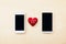 Red heart in between two smartphone, Love line and connection