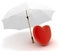 Red heart under umbrella on white