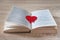 Red heart used as brand pages on the open book