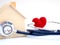 Red heart using stethoscope on the blue background for house health check. Concept of love and caring patient house by the heart.