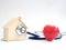 Red heart using stethoscope on the blue background for house health check. Concept of love and caring patient house by the heart.