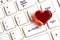 Red heart on a white computer keyboard. The concept of gifts for Valentine`s Day, love correspondence and meeting on social