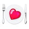 Red heart on white plate, metal knife and fork