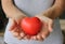 Red heart on woman\'s hands  embracing life