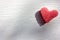 Red heart on wooden table. Heart-shaped slice of watermelon on white background.