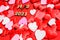 Red hearts background and a love padlock committed to Valentine`s Day in 2021