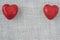 Red Hearts on Burlap Background