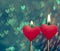 Red hearts candles on vintage hearts bokeh as background
