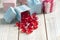 Red hearts and colored gift boxes on wooden background