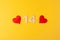 Red hearts, golden numbers 14 on yellow background, greeting card february valentine's day